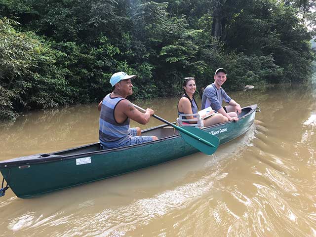 Clinic students Susan Shapiro and Kyle Heitmann with tour guide discussing the effects of the Chalillo Dam on the Macal River.