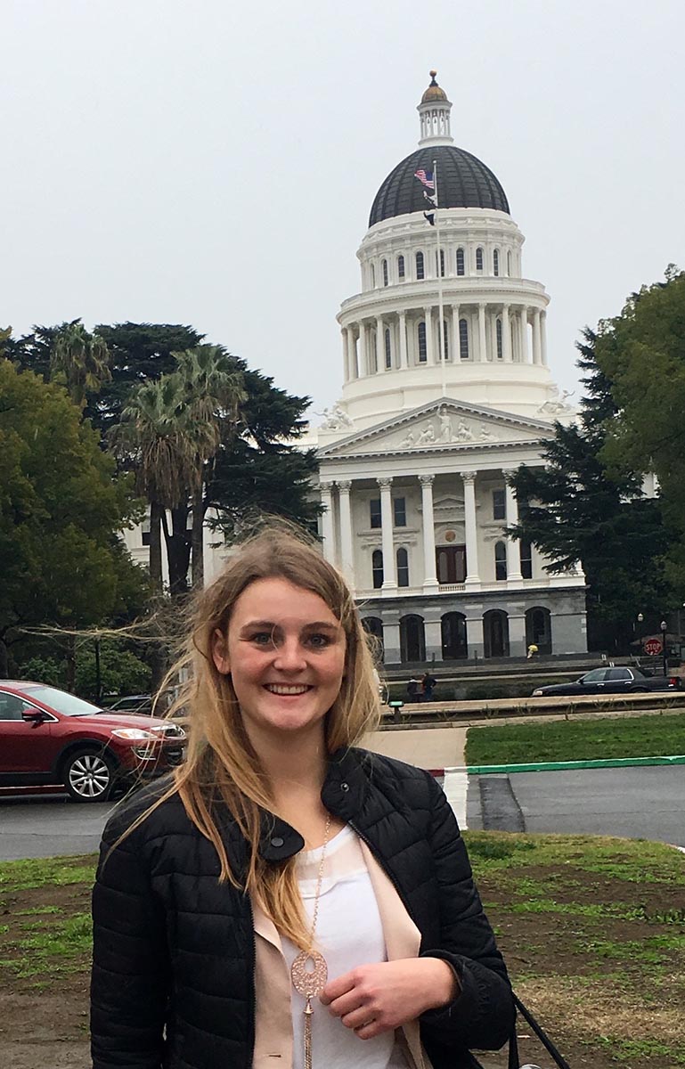 IHRC Student Attorney Benita Bentlage in front of the state capitol building in Sacramento.