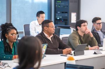 students sit in lecture hall 