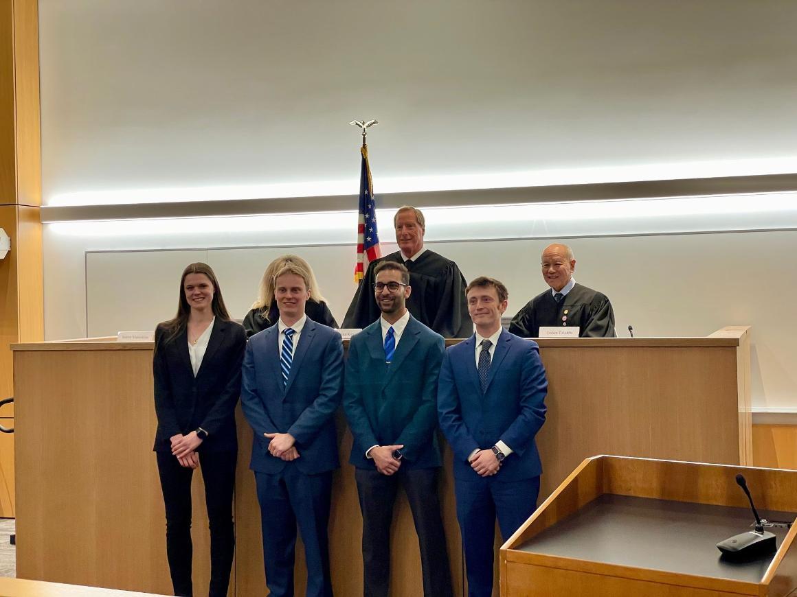 Picture of Judges in their judicial robes and Finalists in business attire in a court room