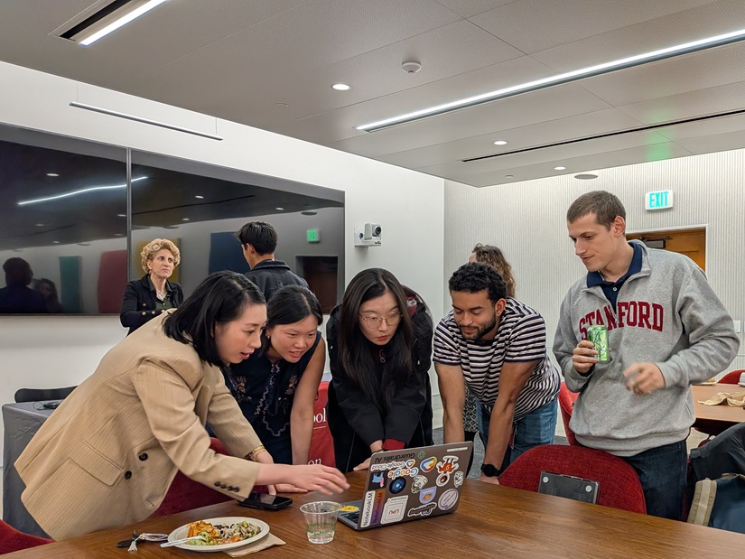 Students looking at a demo on a laptop