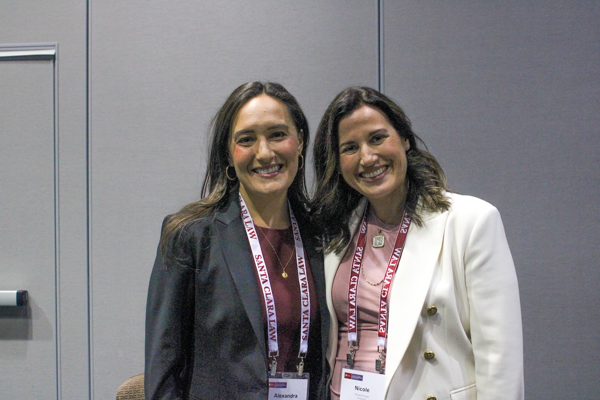 two women smiling at Kasner Symposium