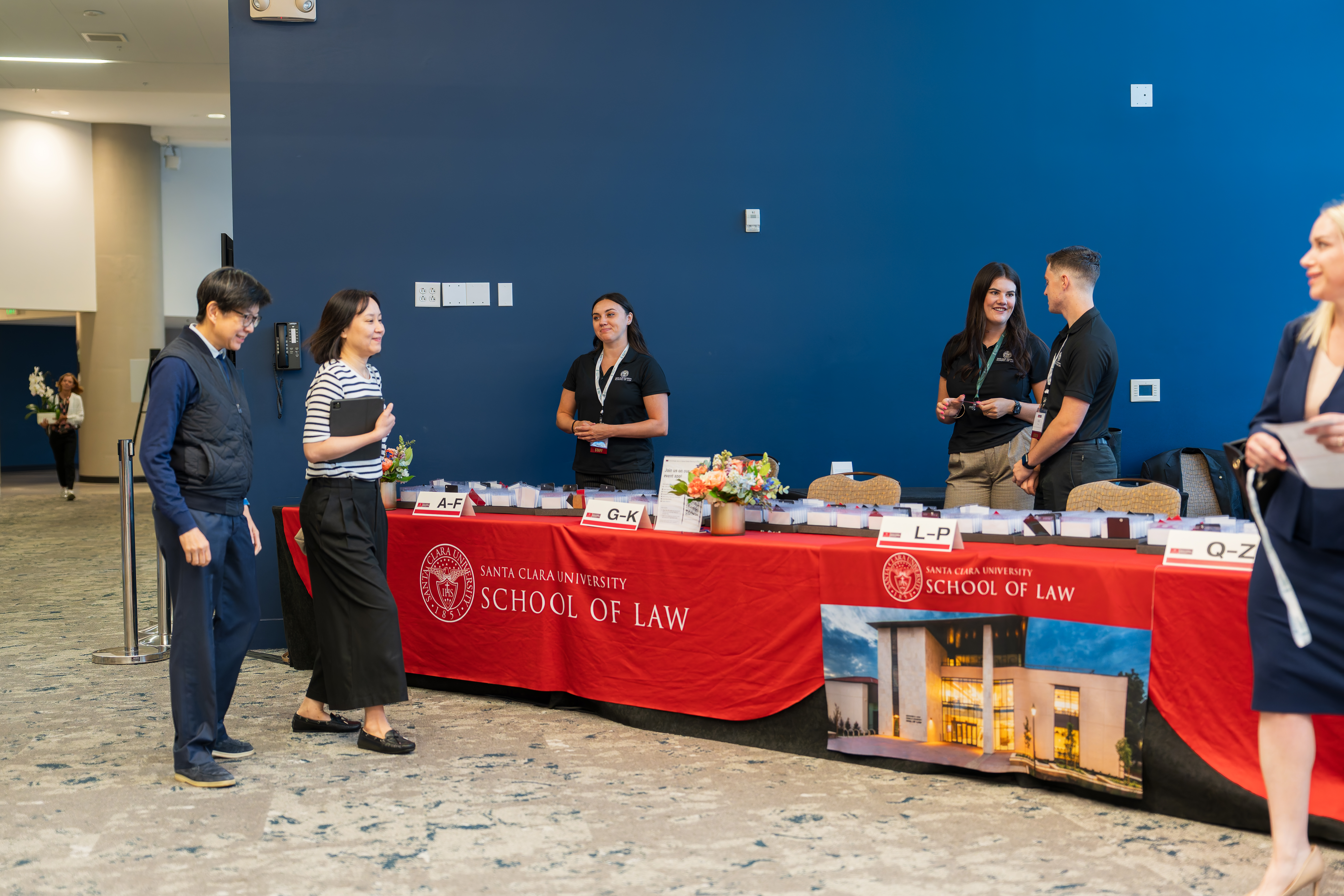 staff at a welcoming table for visitors at an event