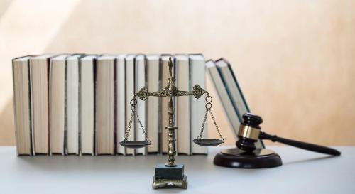 stock image of legal books, scales and gavel