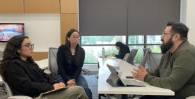 Attorney and students sitting in chairs