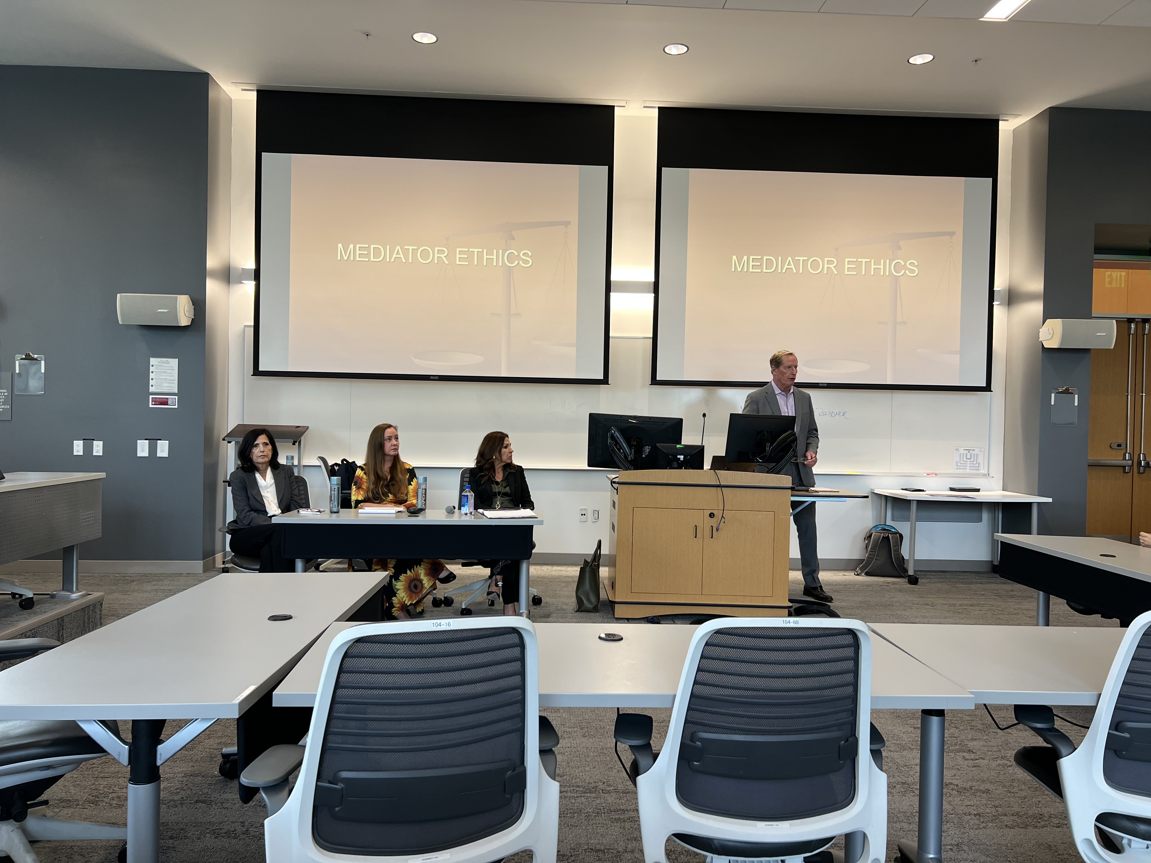 A classroom of staff and teachers doing a presentation at an event