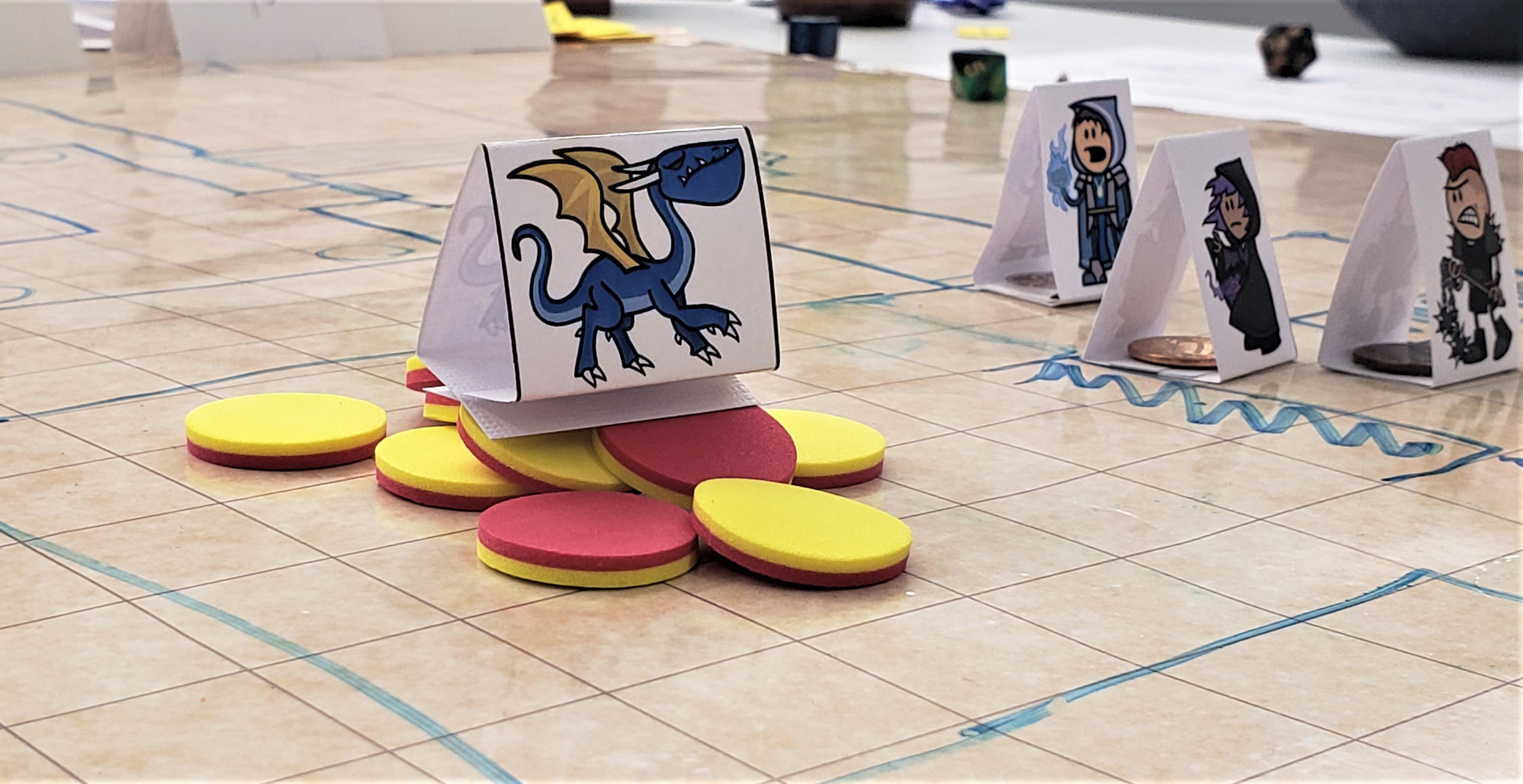 A game board with game pieces from D&D. It has a game piece with a picture of a Blue Dragon with yellow wings on top of red and yellow game chips.