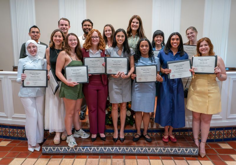 students holding certificates recognizing them as recipients of the law deans leadership award