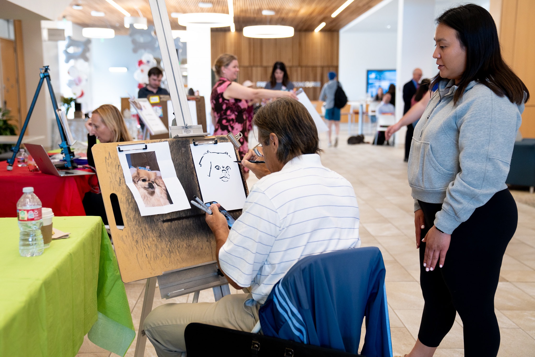 Caricature Artists in Charney Hall Atrium Sketching Dogs