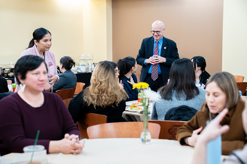 Dean Kaufman talks with students at the First-Generation Luncheon 2024