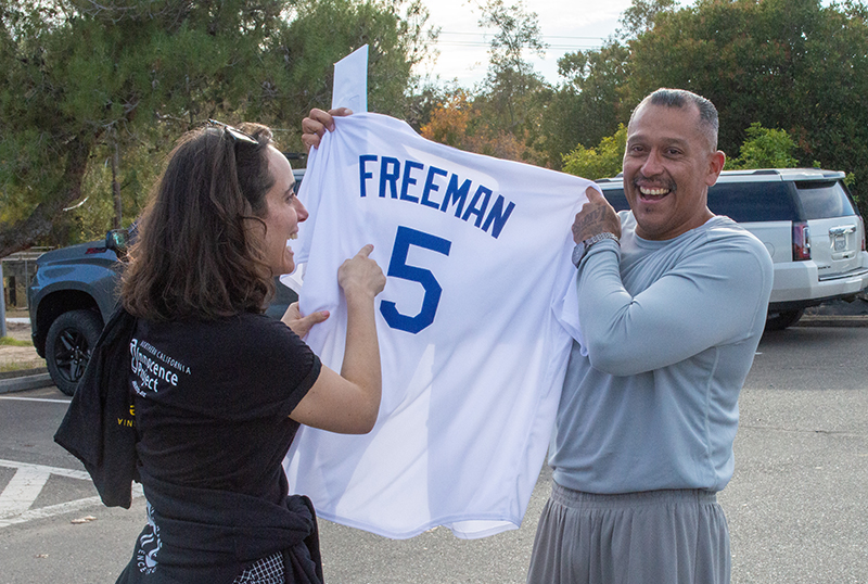 Exonoree Miguel Solorio showing off his new Dodgers Freddie Freeman jersey representing him being a Free Man, and NCIP Staff Attorney Sarah Pace