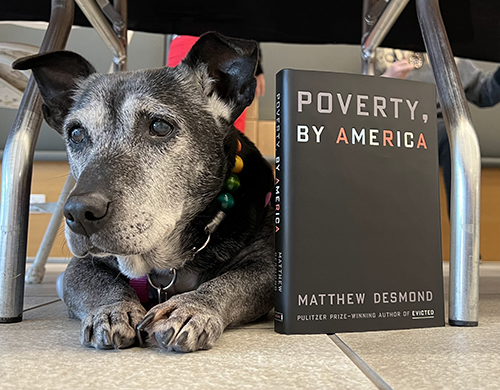 Delilah with book "Poverty, By America"