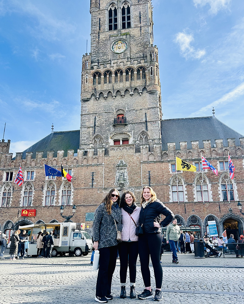 Lexie Legaspi (3L), Kyra Soares (3L), and Alisha Hacker (3L) at the Belfort (Belfry) in Bruges, Belgium.