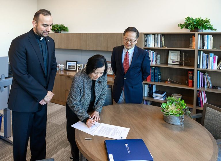 Rector of ITESO, Luis Arriaga S.J. with Santa Clara Law Interim Dean Han and CGLP Director Professor Yang signing an exchange agreement between SCU Law and ITESO in the Dean's Office, February 11, 2020.