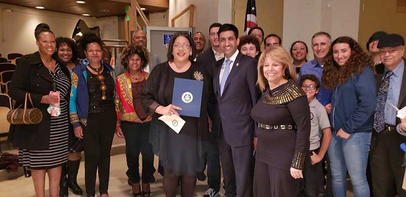 Aileen Casanave (holding Congressional Award) with Representative Ro Khanna.
