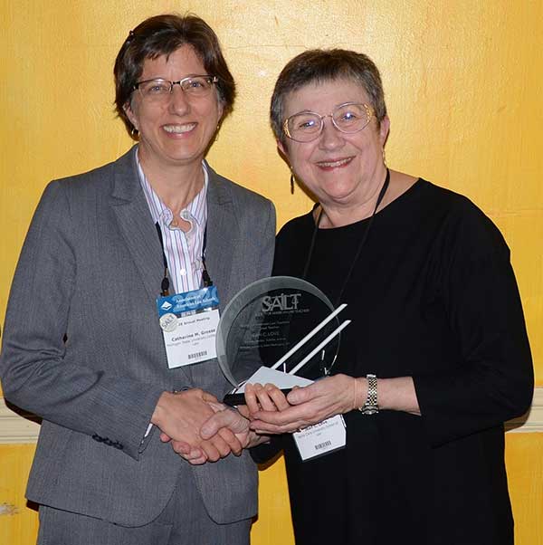 Professor Jean Love (right) receiving the award from her former student, Professor Catherine M. Grosso from Michigan State University School of Law.