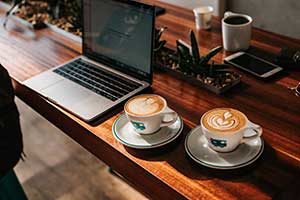 Photo of coffee drinks and laptop by Tyler Nix